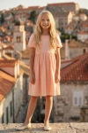 Robe Sia rose, silhouette entière de face dans une vieille ville
