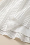 Robe Rozalia blanche – détail du bas plissé et de la doublure lisse