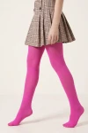 Collants fuchsia opaques portés avec une jupe plissée à carreaux – vue de côté, en marche